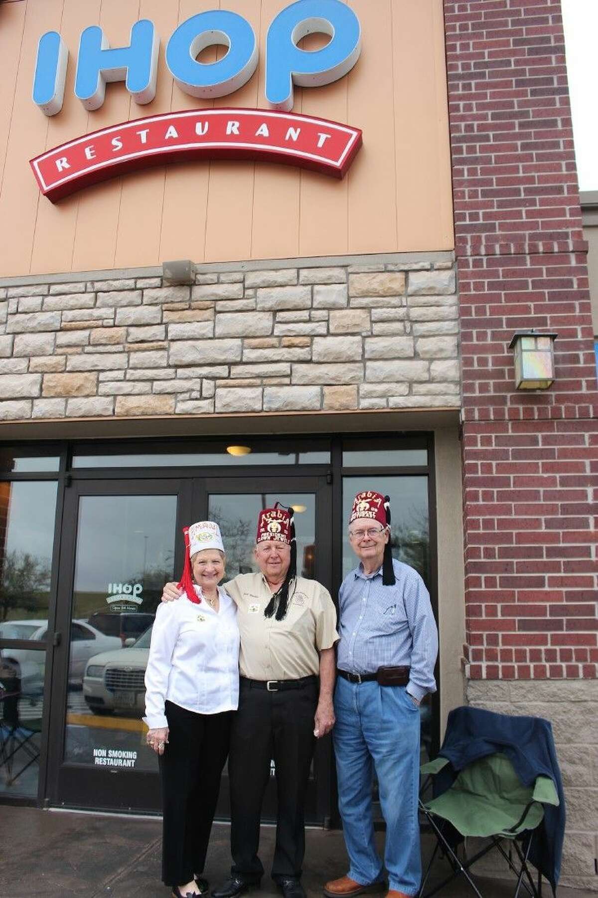 Karen Walker, Bill Walker and Virgil McDonald collect donations for Shriners Children's Hospitals at IHOP in west Pearland on National Pancake Day.