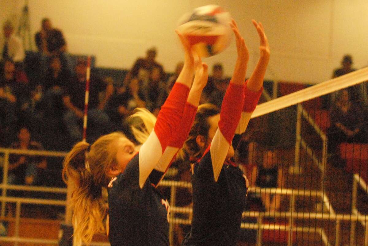 Plainview's Layne Mustian, left, and Harlee Davis try to block a shot during a volleyball match earlier this season. The duo combined for eight kills in a District 3-5A match against Canyon Saturday.