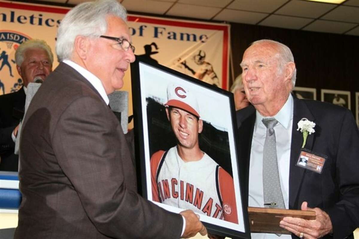 Bill Henry (right) receives his Pasadena ISD Athletics Hall of Fame portrait from Hall of Fame President Terry Brotherton during induction ceremonies in 2012.