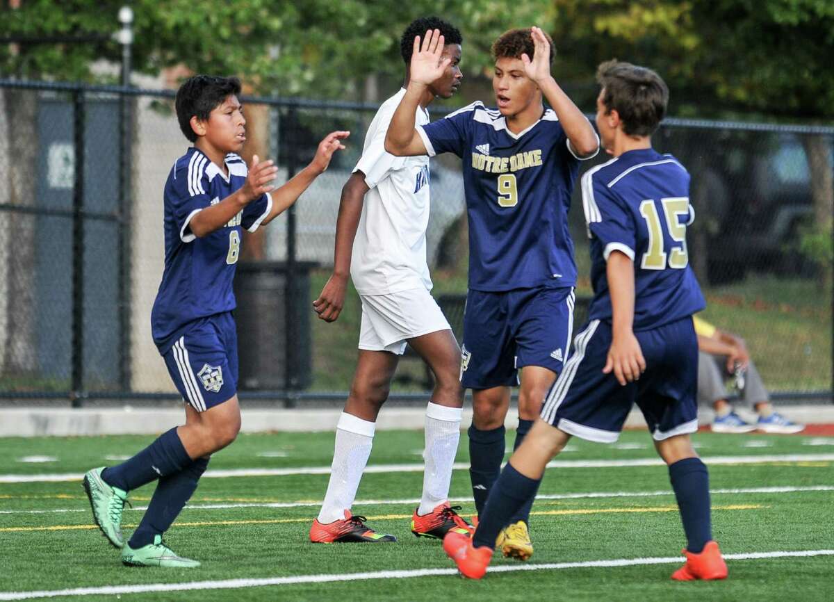 At left, Notre Dame’s Jeff Franco is congratulated by teammates after scoring a first-half goal.