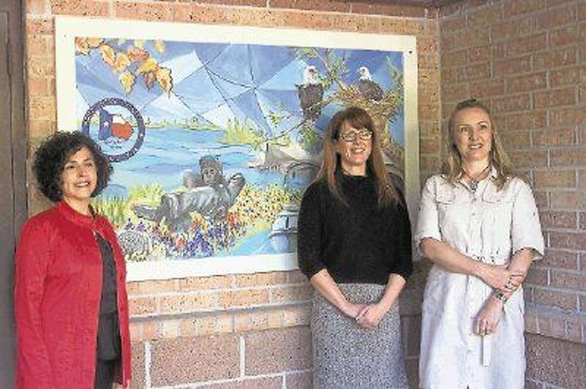 WWAF 2014 Community Art Collaborators Jenny Wright, WWAF Director, Allison Hulett, MOW Exec Director and Carolina Dalmas, Artist with Woodlands Art League show off a mural, part of “Woodlands Alive,” a two-panel art mural installed at The Woodlands Friendship Center’s Meals on Wheels location.