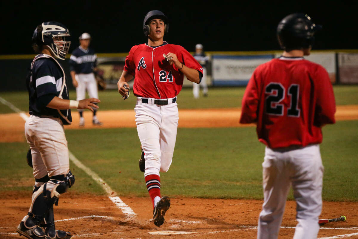 Atascocita's Matt Willrodt (24) tags home after being batted in during the high school baseball game against College Park on Friday, April 10, 2015, at College Park High School. To view more photos from the game, go to HCNPics.com.