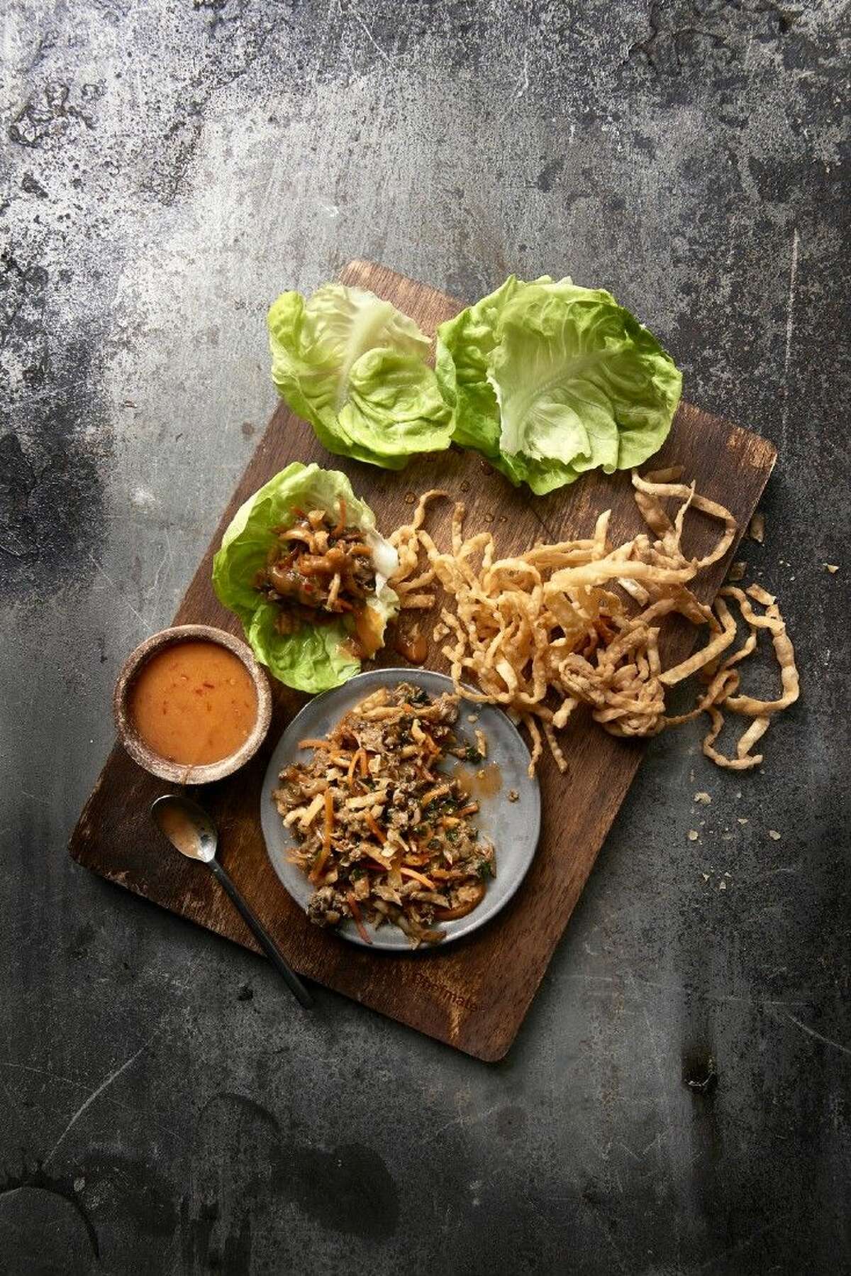 The Asian Duck wraps feature duck confit sautéed with shaved carrots, Napa cabbage, cilantro and shiitake mushrooms with house-made hoisin, crispy wonton strips, chili mustard sauce and bibb lettuce.