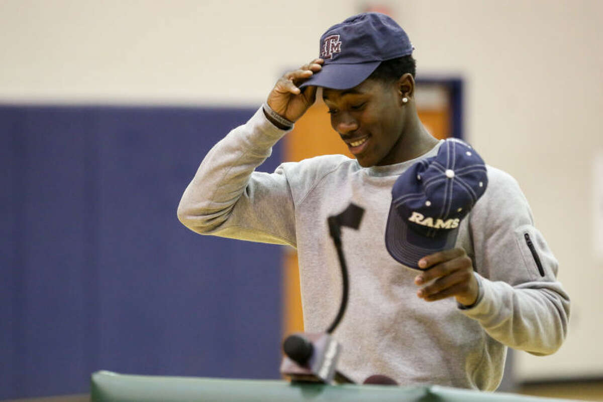 Cy Ridge wide receiver Kemah Siverand dons a Texas A&M hat as he verbally commits to the Aggies on Thursday at Cy Ridge High School.