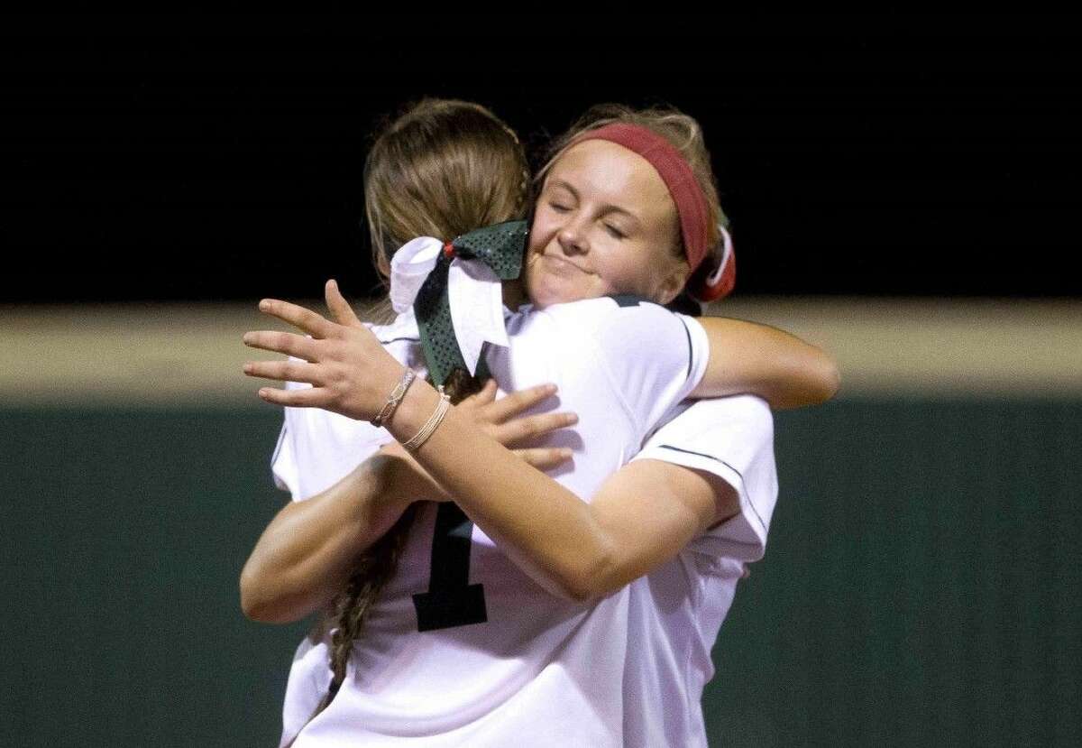 The Woodlands pitcher Emily Langkamp gets a hug from third baseman Caitlin Stavinoha in Mumford Friday.