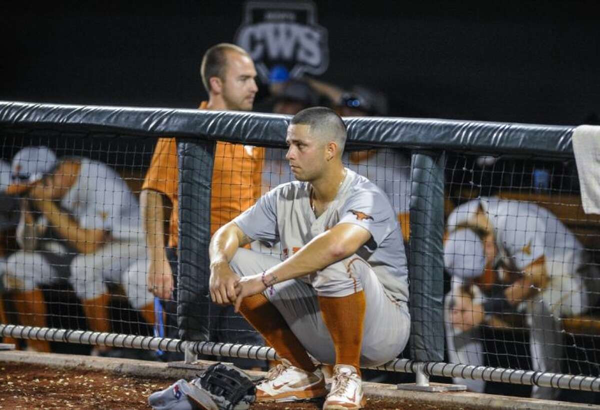 Texas shortstop C.J Hinojosa watches Vanderbilt’s celebration outside the Longhorns’ dugout after the Commodores rallied for a 4-3 victory in 10 innings on Saturday night.