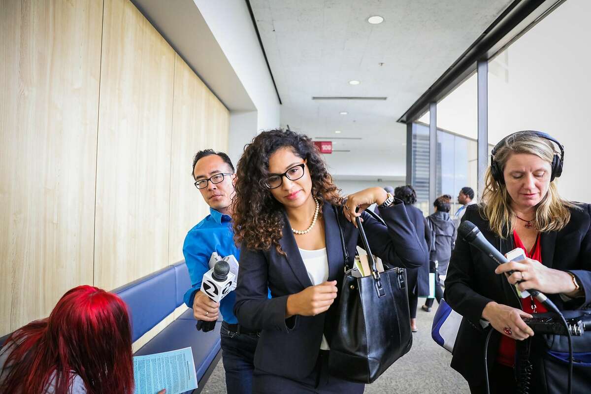 Defense attorney Fatima Silva (center), who is representing Daniel Black, a former Livermore police officer, walked through the hallway after his arraignment at the Wiley W. Manuel Courthouse in Oakland, California, on Tuesday, Oct. 4, 2016. Daniel Black was not present and his attorney appeared on his behalf.