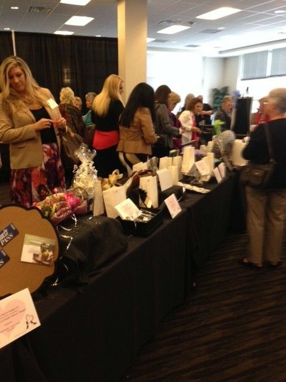 Guests participate in the Razzle Dazzle silent auction at the Hearts in Heels Benefit Luncheon.