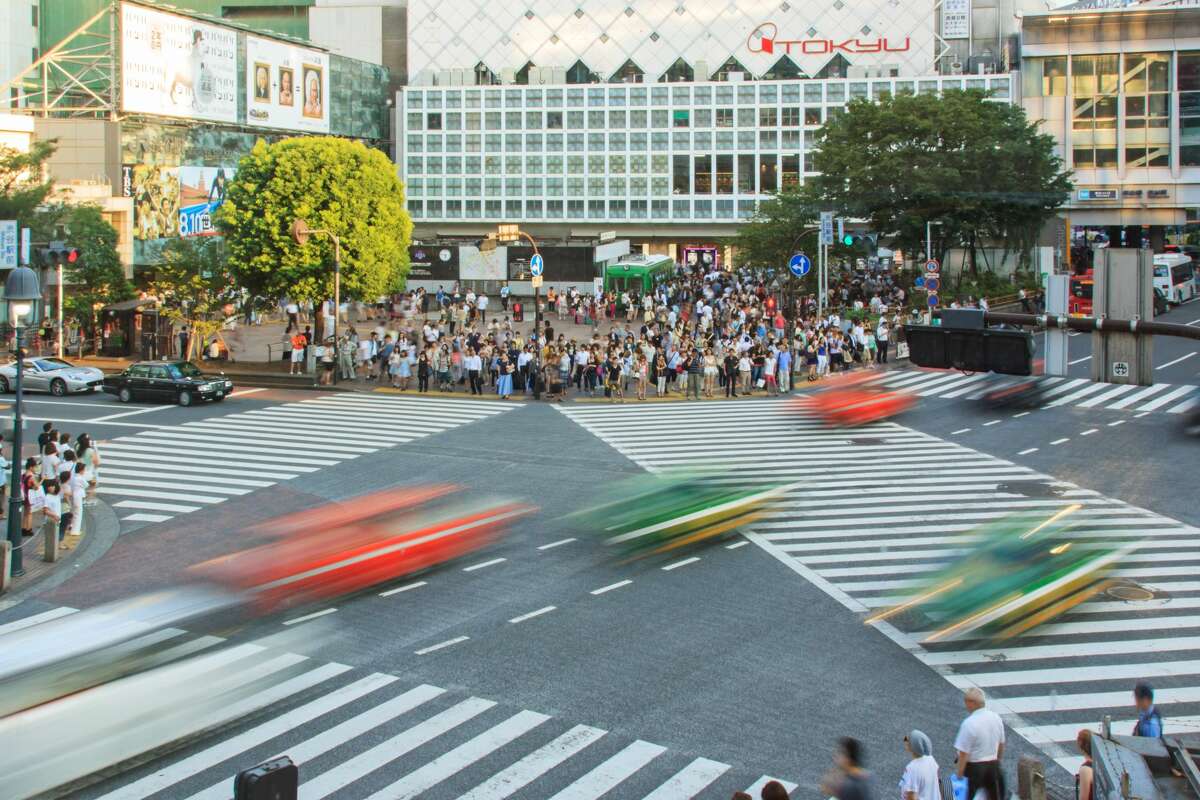 [UNVERIFIED CONTENT] Famous crossroad in Shibuya, Tokyo, Japan aerial view at sunset, cars in motion.