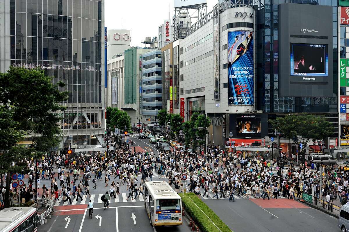 This picture taken on June 21, 2008 shows pedestrians crossing the Shibuya intersection in Tokyo. Shibuya is one of the city's most colorful and busy districts believed to be birthplace to many of the country's fashion and entertainment trends. AFP PHOTO/PHILIPPE LOPEZ (Photo credit should read PHILIPPE LOPEZ/AFP/Getty Images)