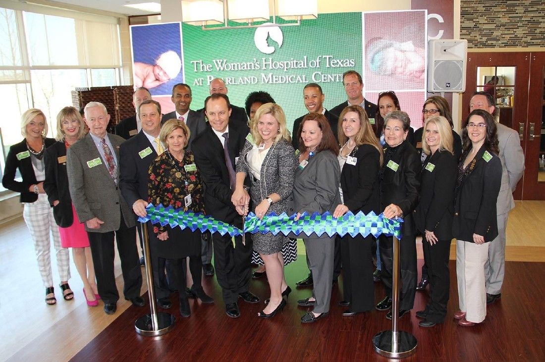 The Woman’s Hospital of Texas at Pearland Medical Center holds ribbon