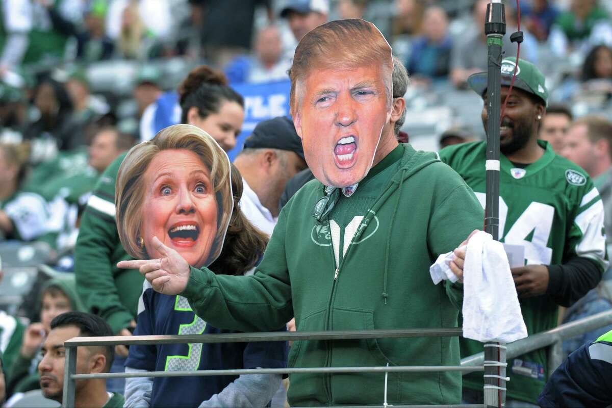 Football fans don masks of presidential candidates Hillary Clinton and Donald Trump during the NFL game between the Seahawks and Jets on Sunday in East Rutherford, N.J. Likewise, readers’ heads are in the political game this election year.
