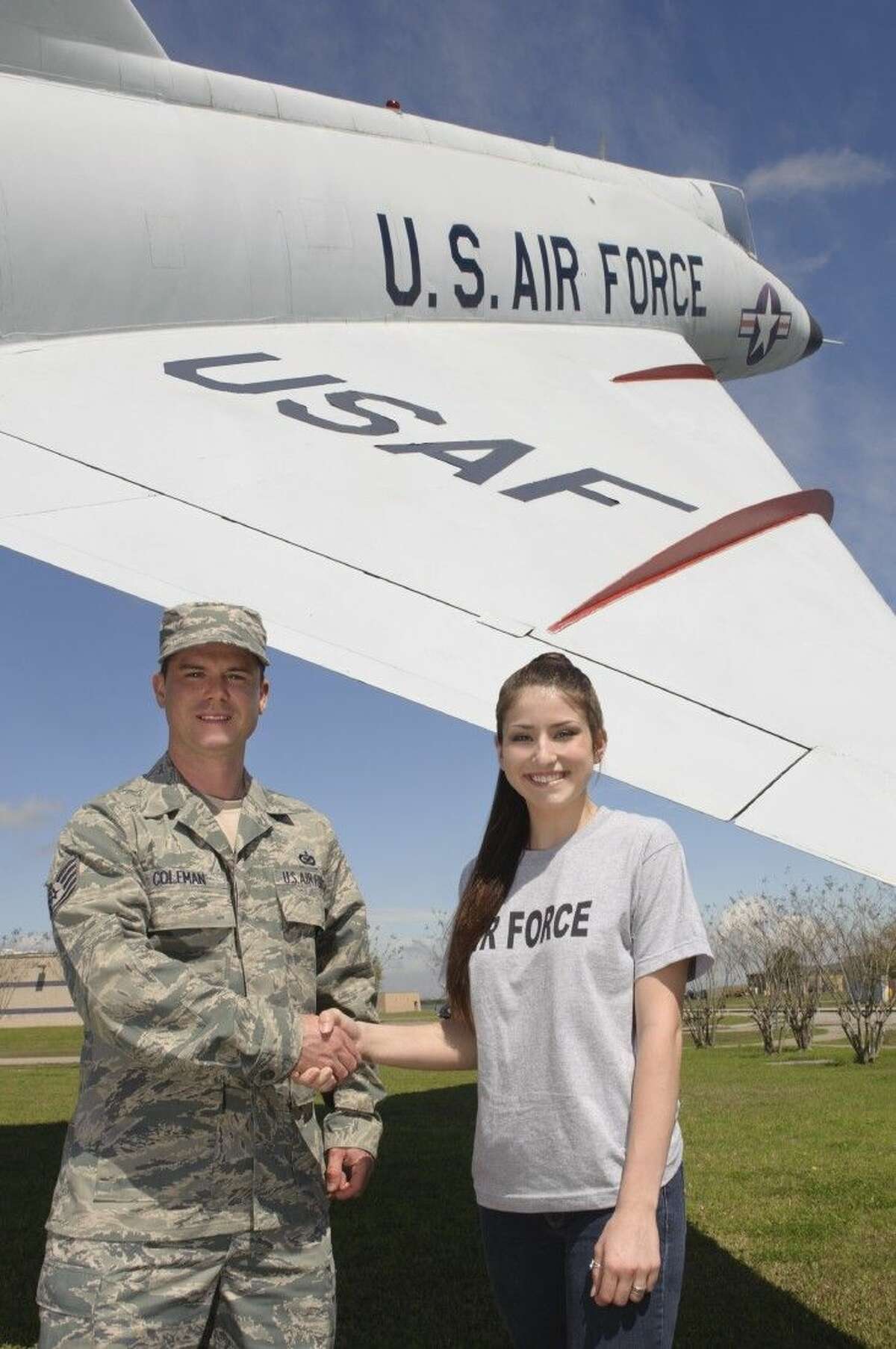 Clear Lake High School graduate Anna Leigh Baker, with TSgt William P. Coleman, enlists in the U.S. Air Force with 24 college credits and will pursue a career in medicine.