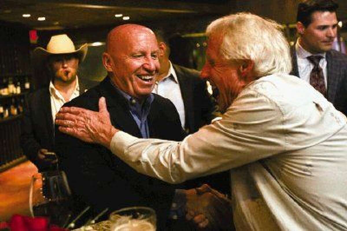 U.S. Rep. Kevin Brady, R-The Woodlands, thanks supporter The Woodlands resident Rick Hughes, right, during Brady’s election night party on Tuesday at Crush Wine Lounge in The Woodlands.