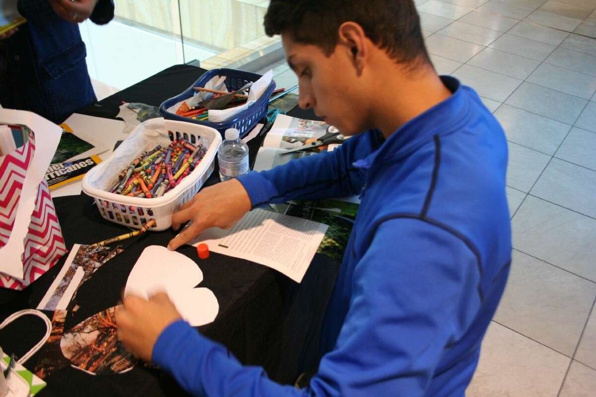 Humble High School IB student Bryan Moreno creates a butterfly to put the final touches on the Holocaust Museum Houston’s “The Butterfly Project” at The Galleria March 11, 2016.