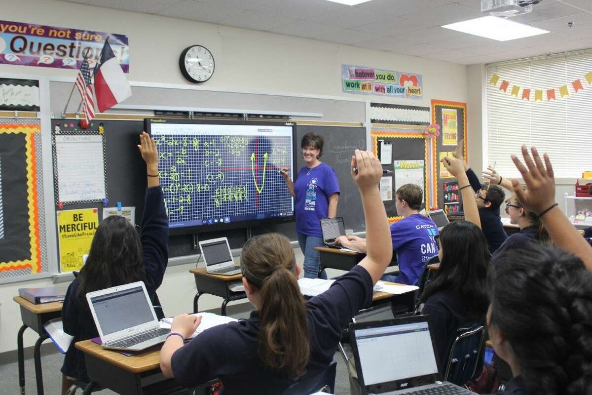 Junior high math teacher Molly Nobile asks students a question while teaching a lesson using the Promethean panels.