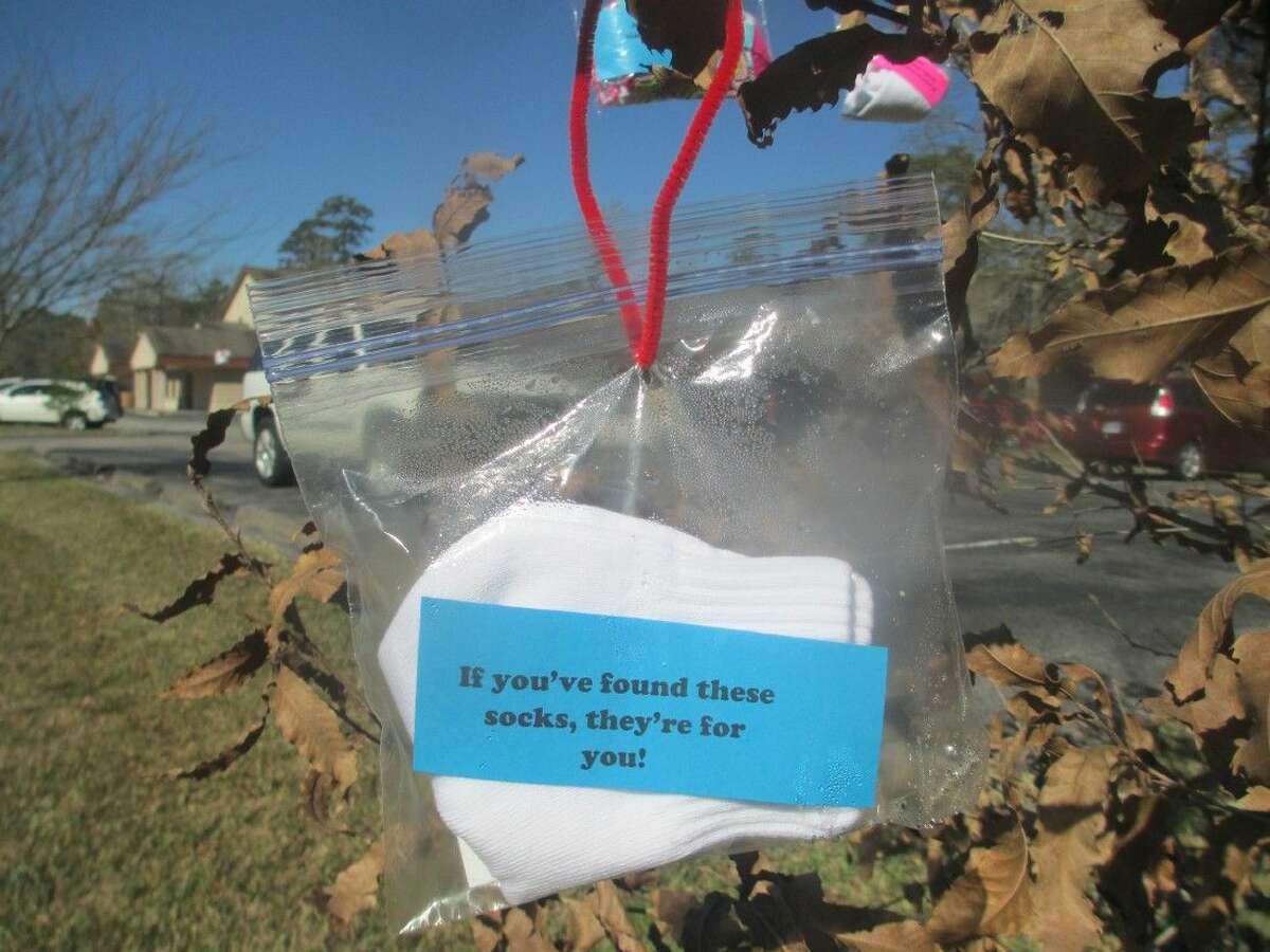 Outside of Kingwood’s Holy Comforter Church and School, small plastic bags have appeared, hanging from trees, including a pair of socks and a special handwritten note for any passerby who might be in need.