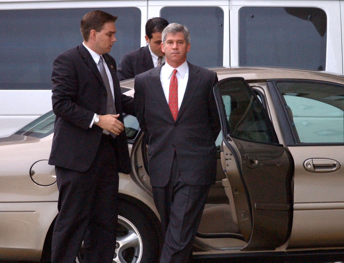 Former Enron Chief Financial Officer Andrew Fastow is escorted to the federal courthouse in Houston after surrendering to the FBI in 2002, shortly after Enron filed for bankruptcy.