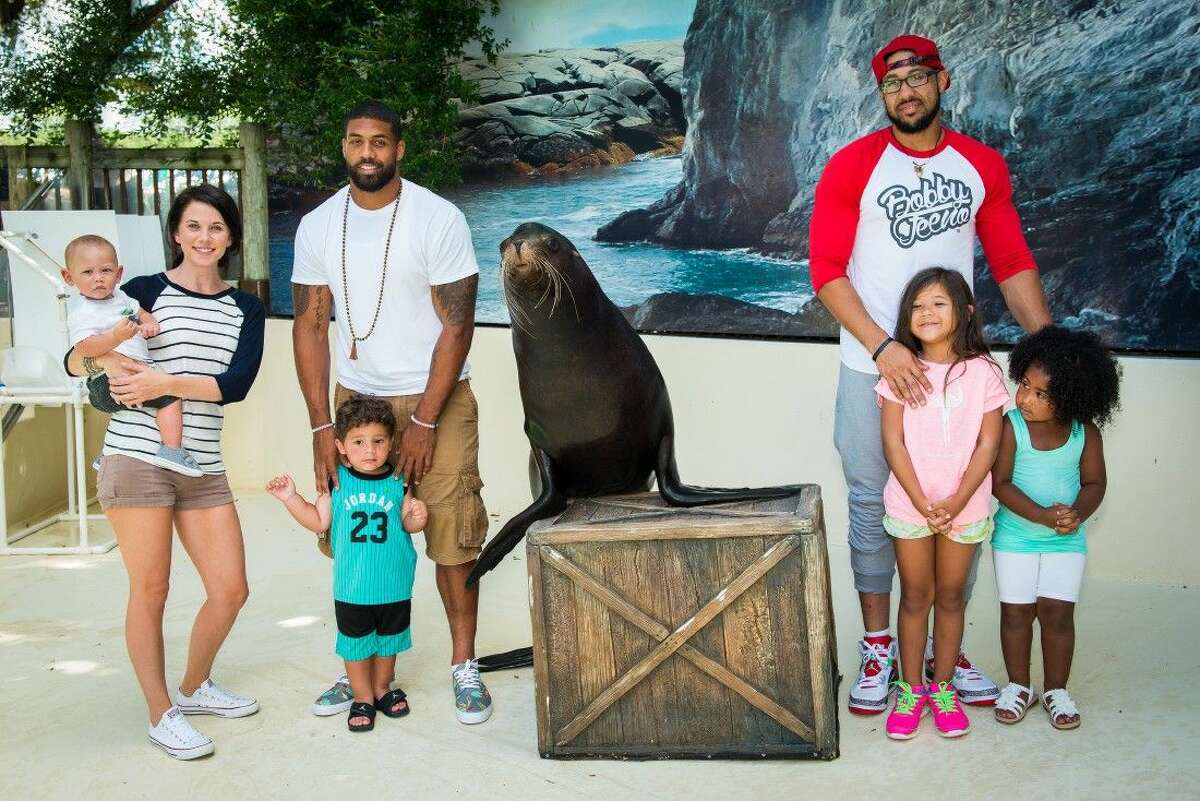 Pictured with Jonah the seal, from left, sister-in-law Chrissy Foster holding Ajani Foster, Arian Foster with son Khyro Foster, Abdul Foster, daughter Zeniah Foster and Naima Foster.