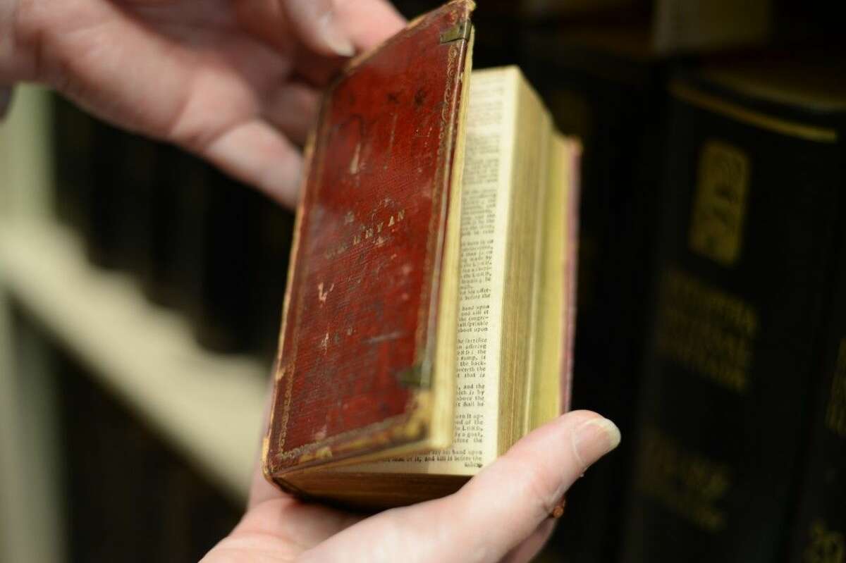 Lisa Struthers turns the pages of a tiny Bible approximately dated 1735. The Bible originated from Stephen F. Austin’s mother and is one of the museum's more recent acquisitions.