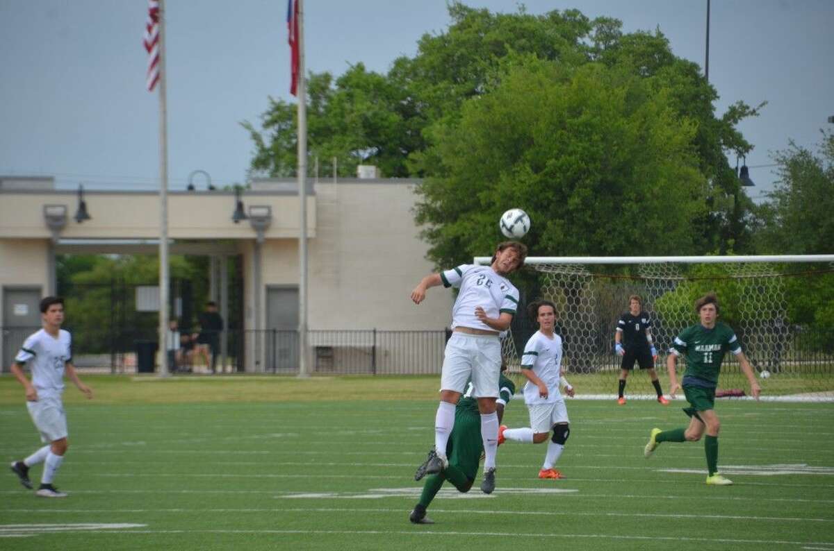 The Woodlands’ Nicholas Pekel (26) heads a ball during the UIL Region II-6A semifinal game Friday in Austin.