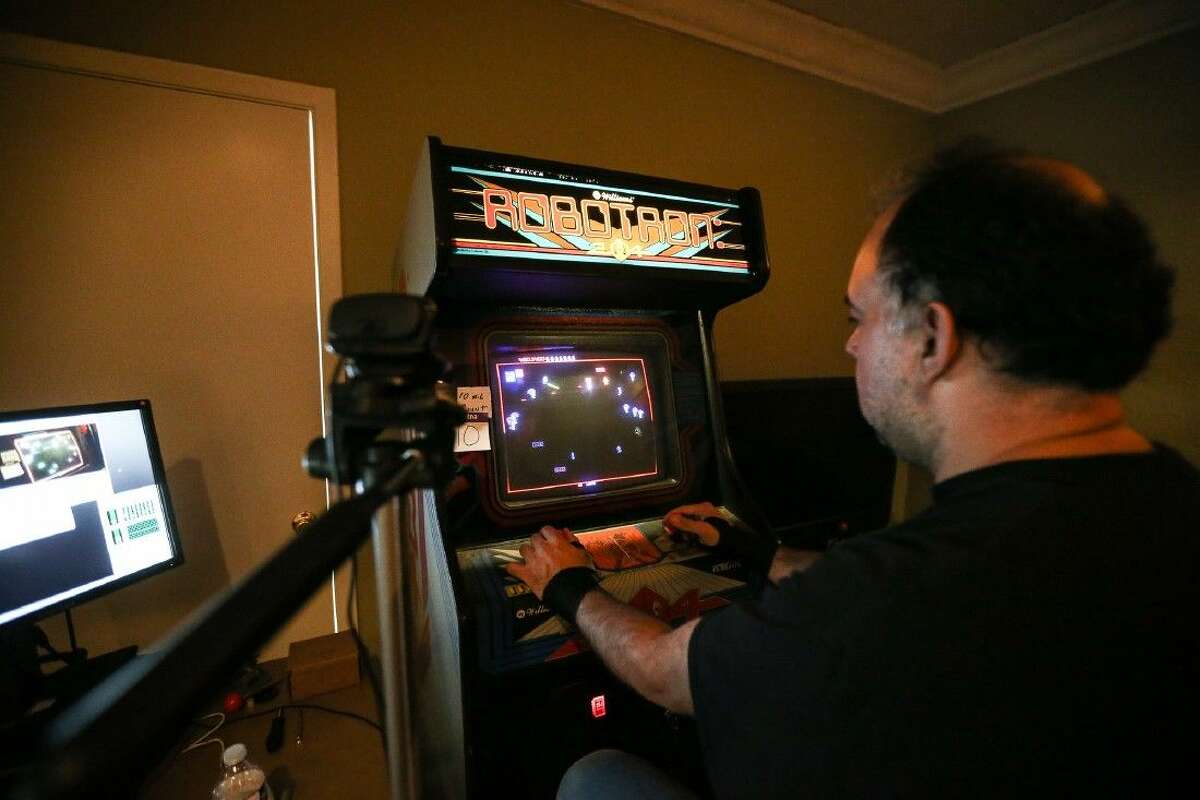 David Gomez, a vintage arcade games enthusiast, enters the 24th hour of a marathon playing Robotron: 2084 on a single credit Sunday at The Game Preserve.