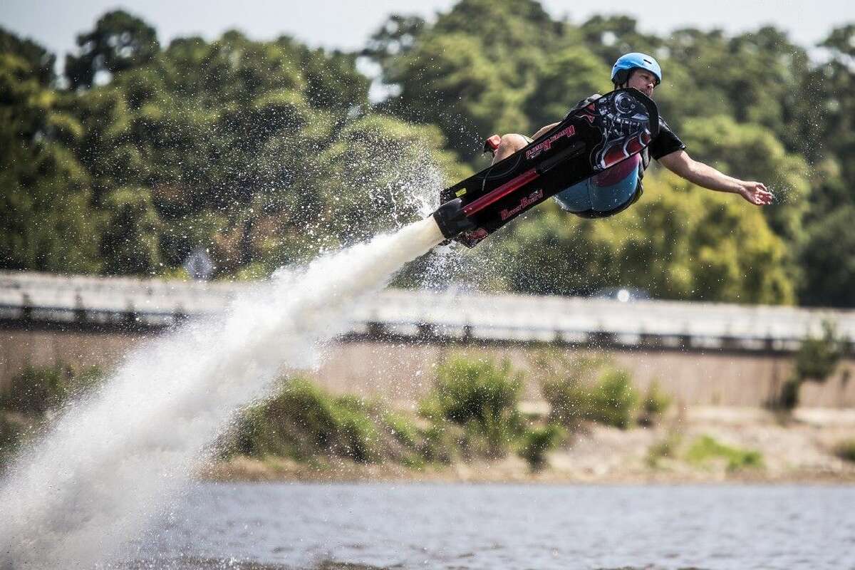 Hover Lake Houston instructor Ben Randell flies through the air on a hoverboard Aug. 1, 2015, in Huffman.