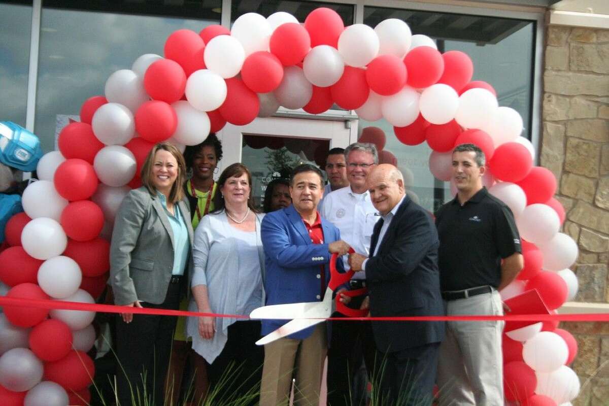 Comcast representatives and city of Humble Mayor Merle Aaron cut the ceremonial ribbon at the grand opening of the XFINITY store in Humble Saturday, Aug. 8, 2015.