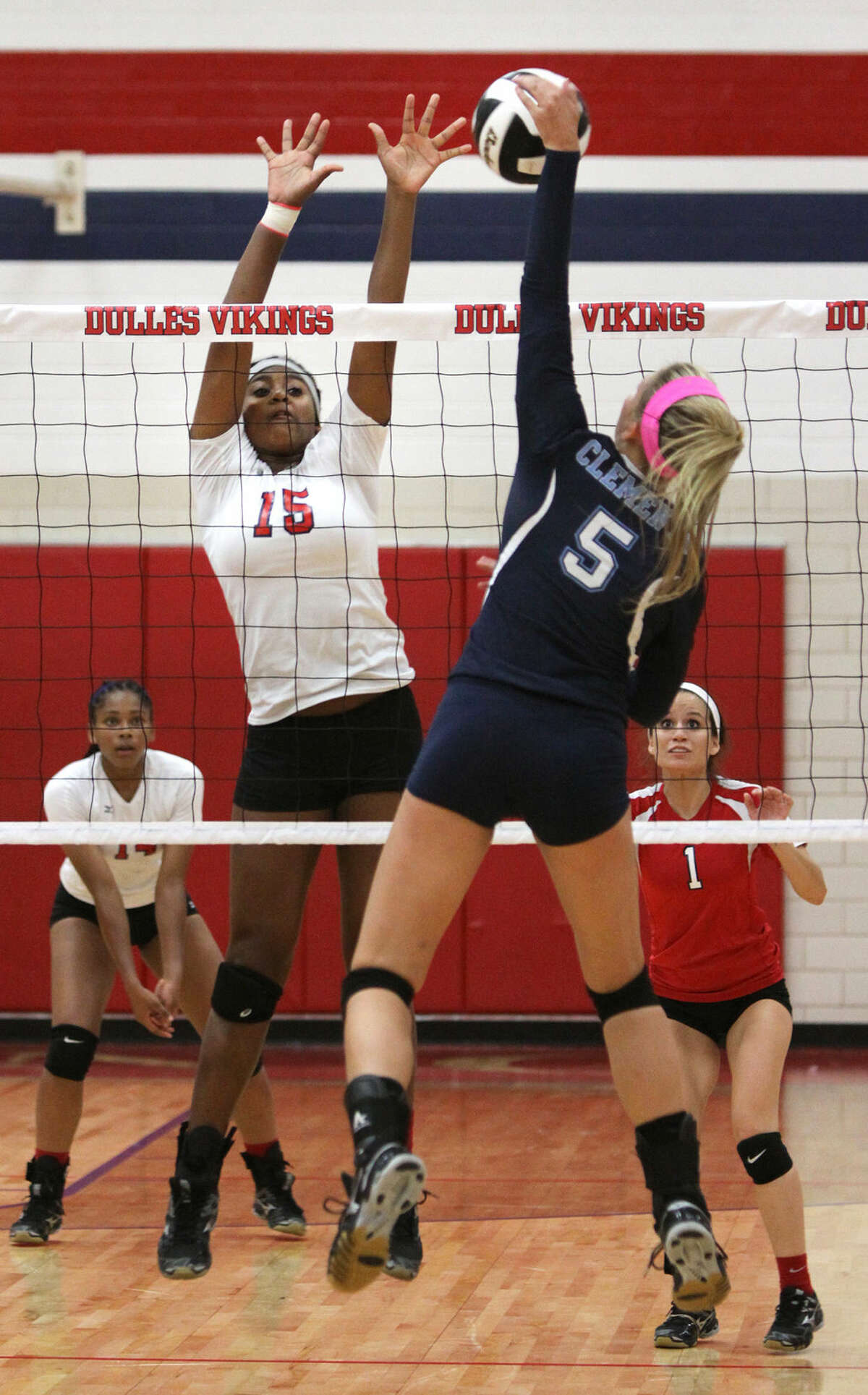 Clements' Lauren Stifflemire spikes against Dulles' Chandler Marshall during their 2014 District 23-6A match at Dulles High School in Sugar Land. The Lady Vikings defeated Alvin on opening night of the 2015 season, while the Lady Rangers split with Pearland and Stratford.