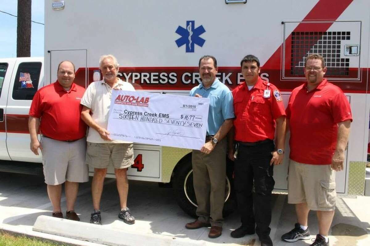 Service Advisor Teak Daniele and Store Manager Robert Benet present a donation to Cypress Creek EMS.