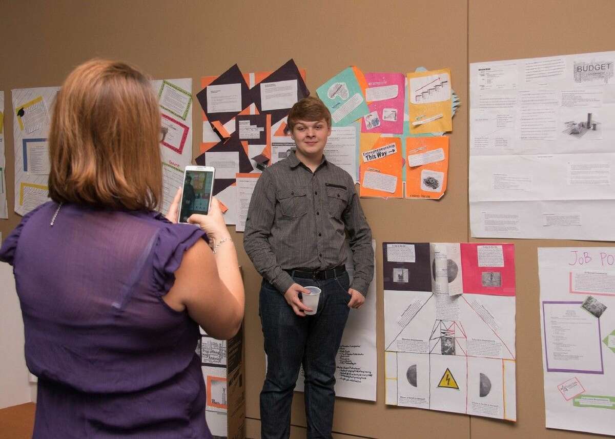 Klein Collins High School senior Ethan Collins poses for a snapshot by the career presentations made by Project GRAD students during a two-week institute at Lone Star College-University Park.