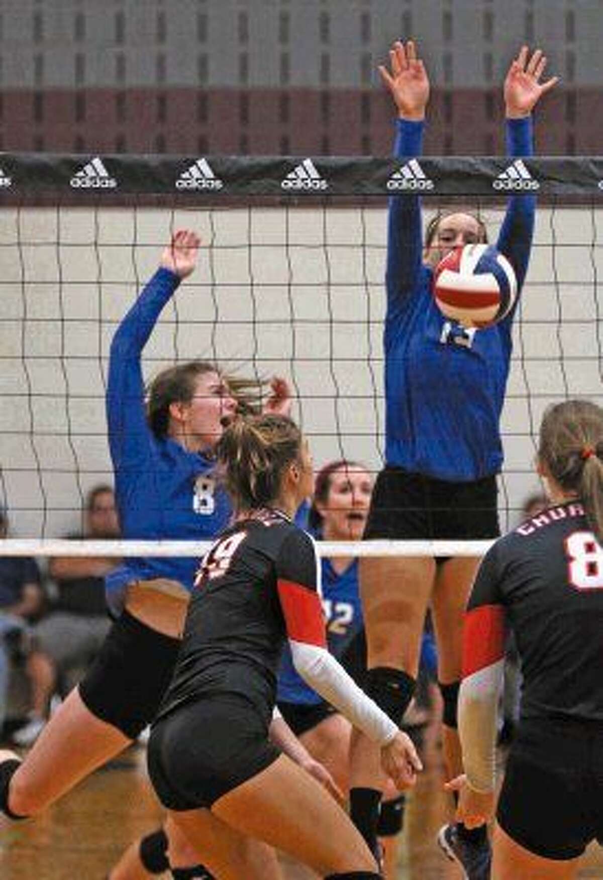 Dalaney Rhoades (13) and Ashlyn Ross (8) of Friendswood defends the net during play at the Adidas Invitational.
