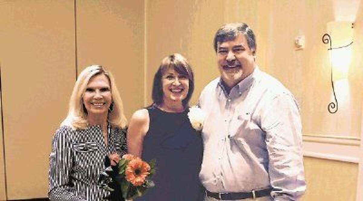President and CEO of Interfaith of The Woodlands Dr. Ann Snyder (left), congratulates Lisa Koetting (center) for being named a 2015 Hometown Hero. Pictured with Koetting is her husband, Fred.