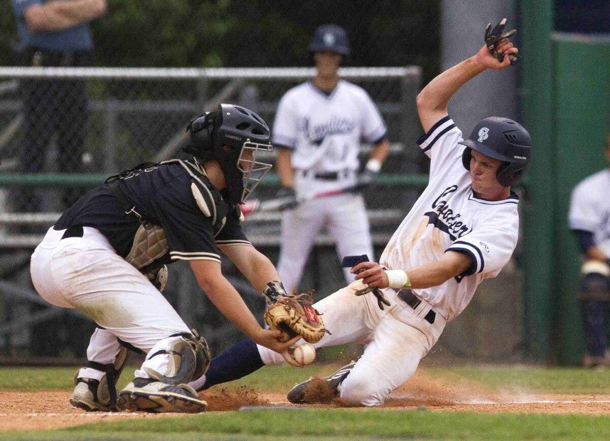 College Park’s Harper Lucas beats the tag by Conroe catcher Scott Horn to score off a suicide squeeze bunt by Travis Washburn during the sixth inning of a District 16-6A baseball game Friday. Go to HCNpics.com to purchase this photo and others like it.