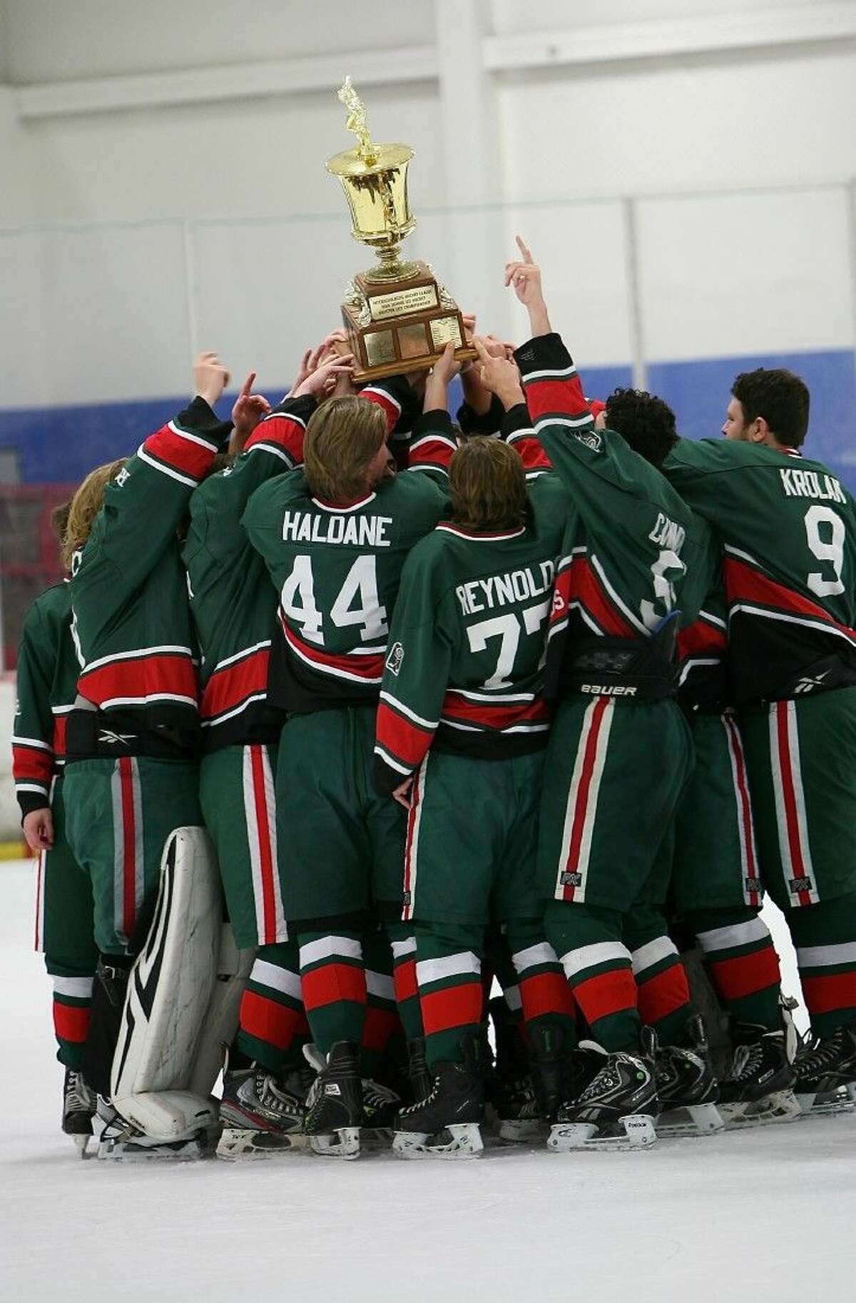 The Woodlands Hockey team celebrates after defeating Cinco Ranch 5-3 in the 2015-2016 ISHL Justice Cup City Championship game.