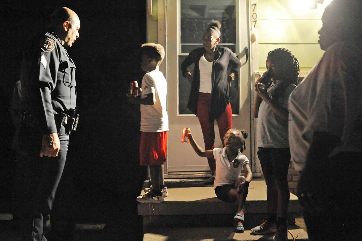 Midland Police Sgt. Jimmy Young visits with community members during National Night Out on Tuesday, Oct. 4, 2016. James Durbin/Reporter-Telegram