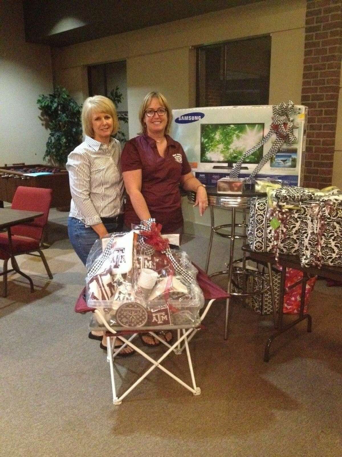 Gayle Keller and Geralyn Sullivan, KH Aggie Moms Tradition Banquet Chairpersons, pictured with some of the great raffle and auction items we will have at the banquet.
