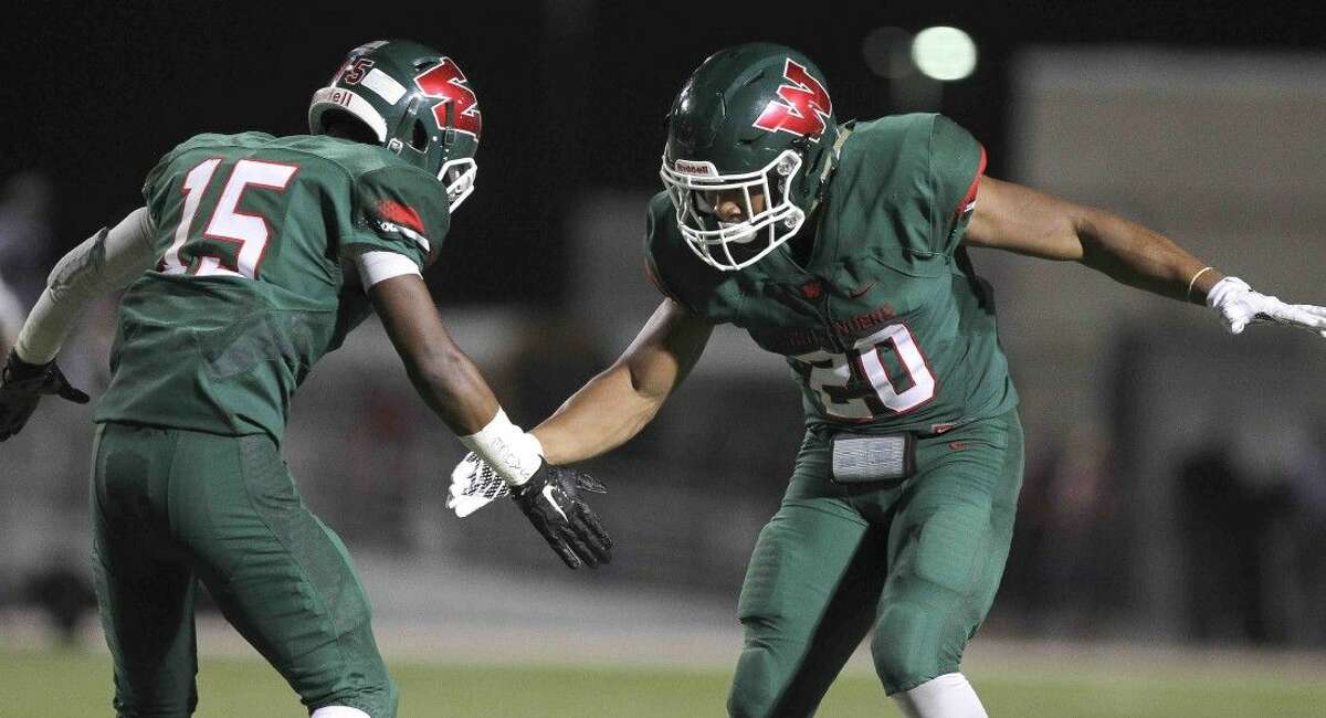 The Woodlands defensive back AJ Mason celebrates with defensive back Antoine Winfield Jr. after intercepting a pass last Friday night.
