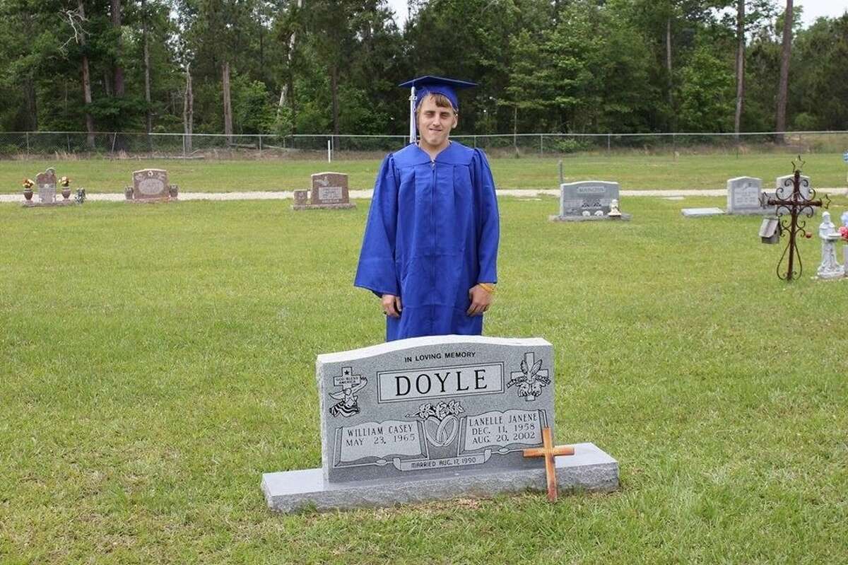 Kalvin Doyle stands behind the headstone of his mother, Lanelle Janene Doyle after graduating from Shepherd High School. Doyle is attending Brenham College and hopes to become a state trooper.