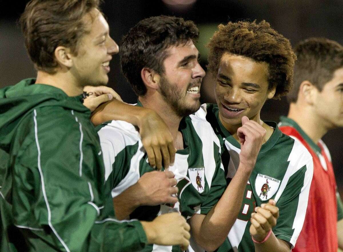 The Woodlands players celebrate with forward Rafael Ortiz, center, after defeating Klein Forest 2-1 during a Region II-6A regional quarterfinal match at Klein Memorial Stadium Tuesday.