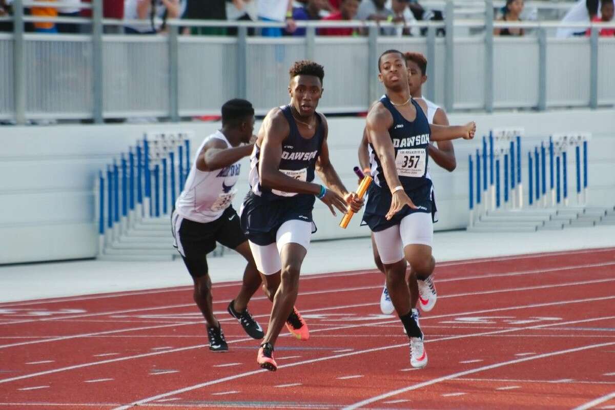 Vincent Fisher hands off to Kameron Hypolite in the second leg of the boys 4x400M relay at the regional track meet final Saturday.