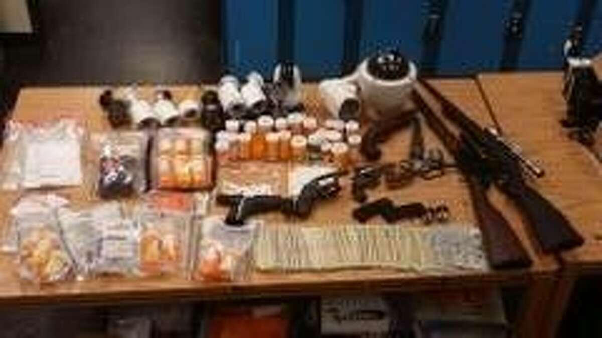 Deputies seized several surveillance cameras, weapons, prescription pills and drugs.