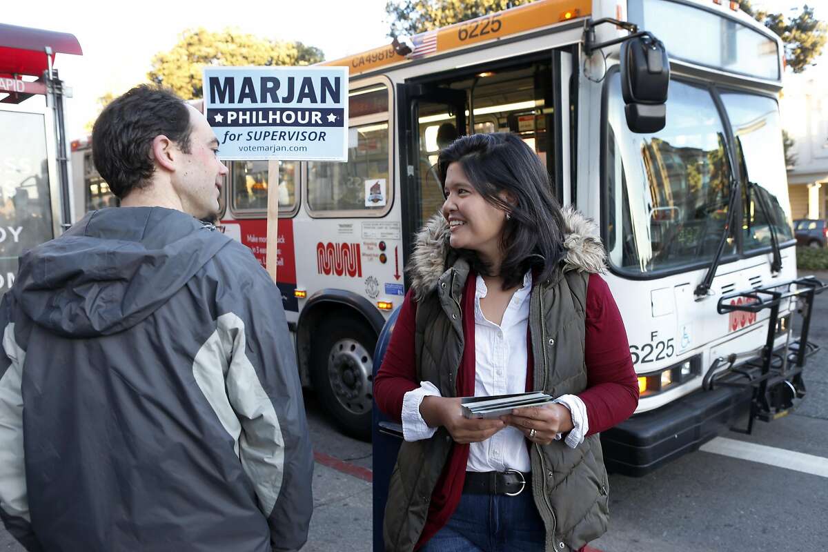 Marjan Philhour, running for Supervisor in District 1, chats with commuters waiting at the bus stop at Geary Boulevard and 25th Avenue in San Francisco, Calif. on Wednesday, Oct. 5, 2016.