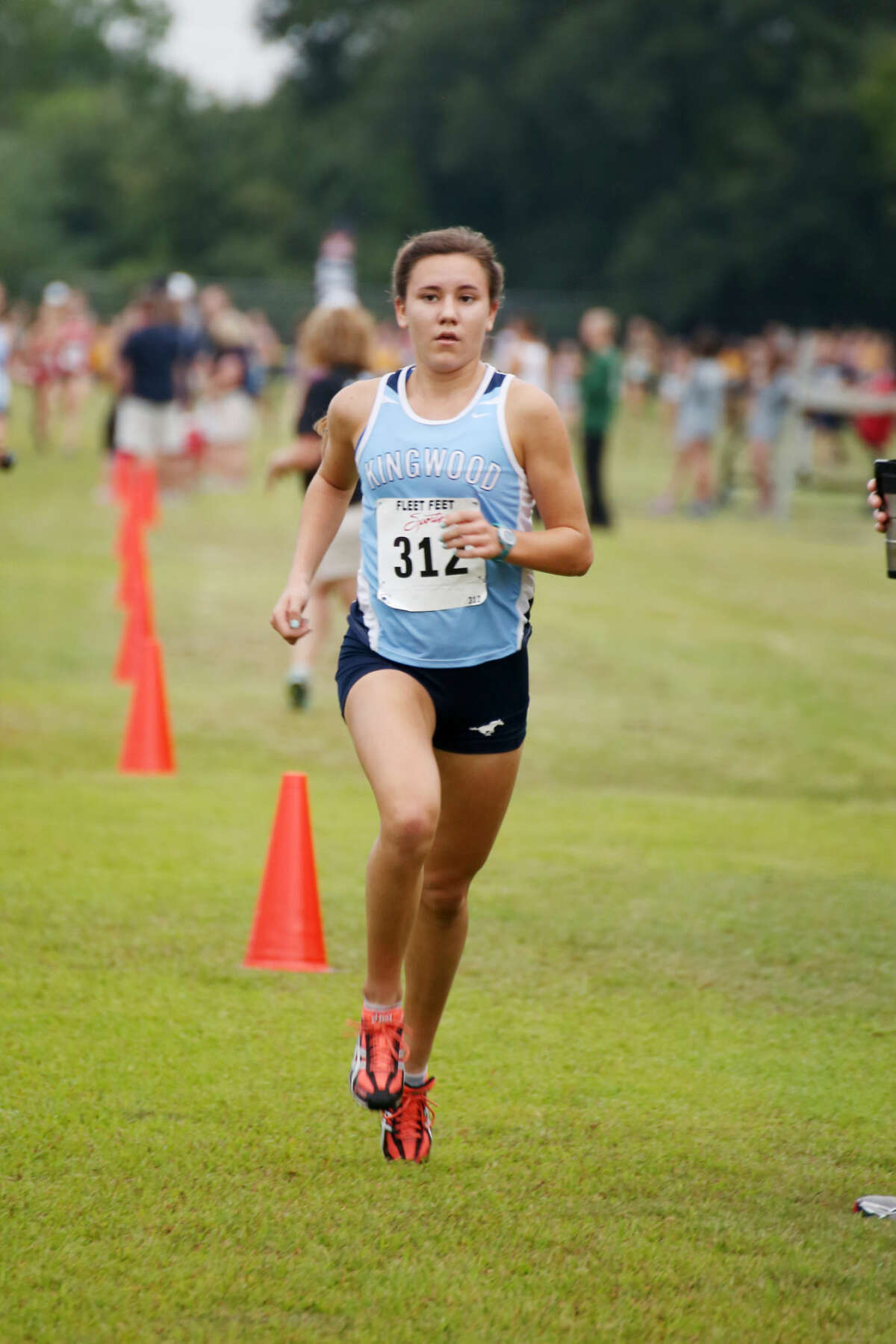 Mustang Abby Guidry on her way to individual gold at the Cy Woods Invitational on Saturday.