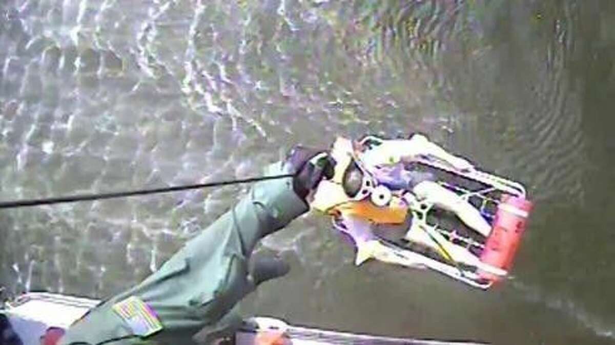 An Air Station Houston helicopter crew drops the rescue swimmer, hoists a man to safety and returns him to the air station to be checked by EMS. U.S. Coast Guard video by Air Station Houston.