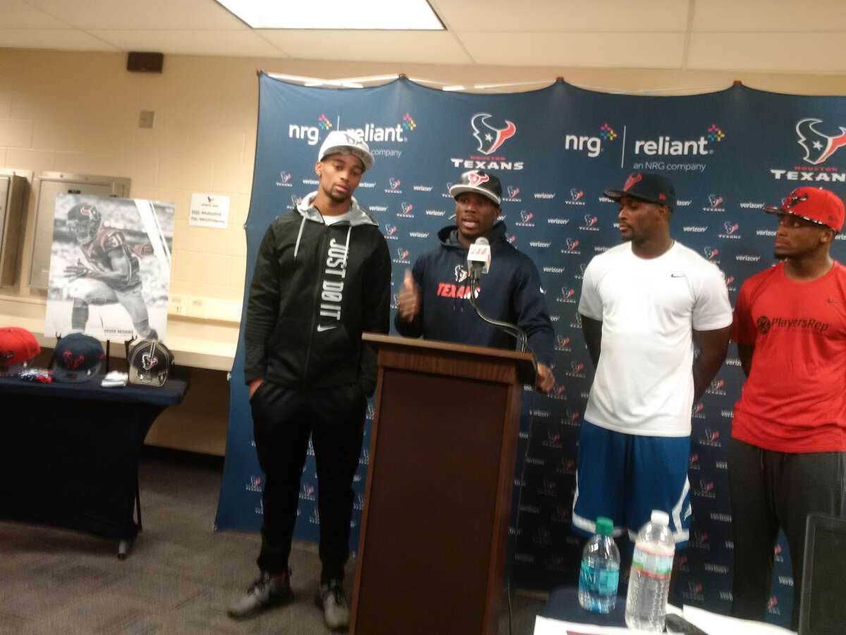Charles James with teammates at NRG Stadium at press conference for debut of hats and sock designs.