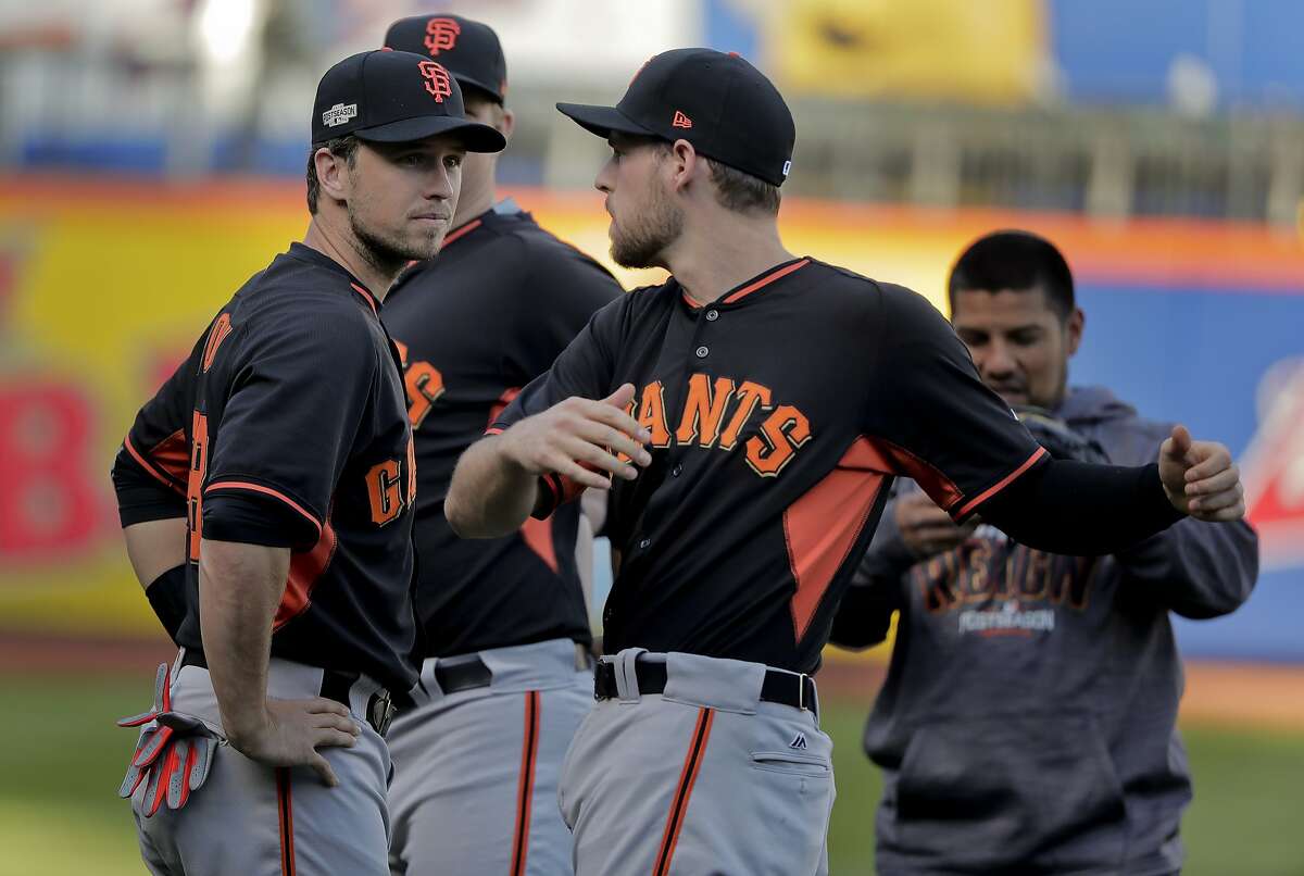 San Francisco Giants catcher Buster Posey, left, and third baseman Conor Gillaspie (21) talk while stretching during workout for the National League wildcard baseball game against the New York Mets, Tuesday, Oct. 4, 2016, in New York. (AP Photo/Julie Jacobson)