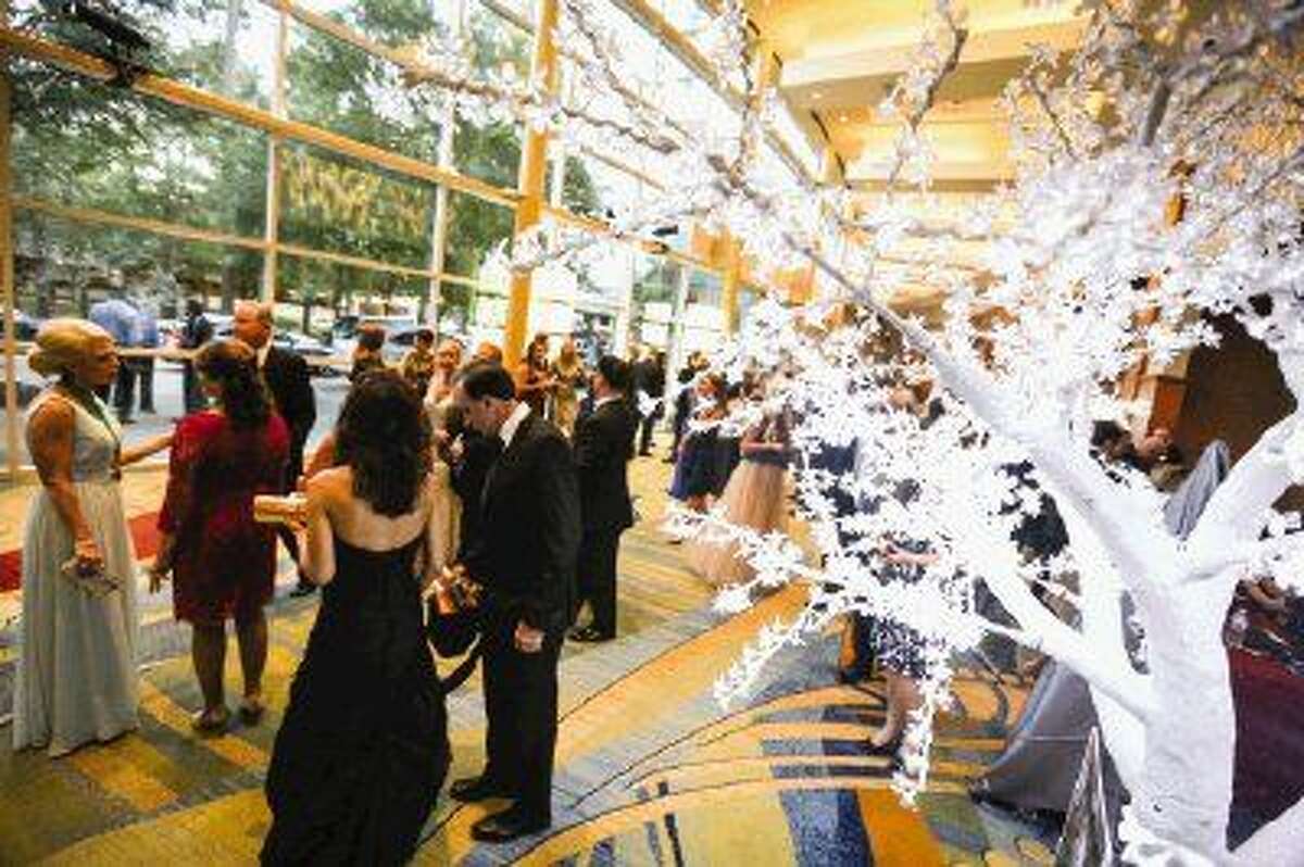 Attendees of the 2015 Celebration of Excellence mingle in a hallways decorated with the fire and ice theme of the evening on Saturday at The Woodlands Waterway Marriott Hotel & Convention Center. To view more photos of the event, go to HCNPics.com.