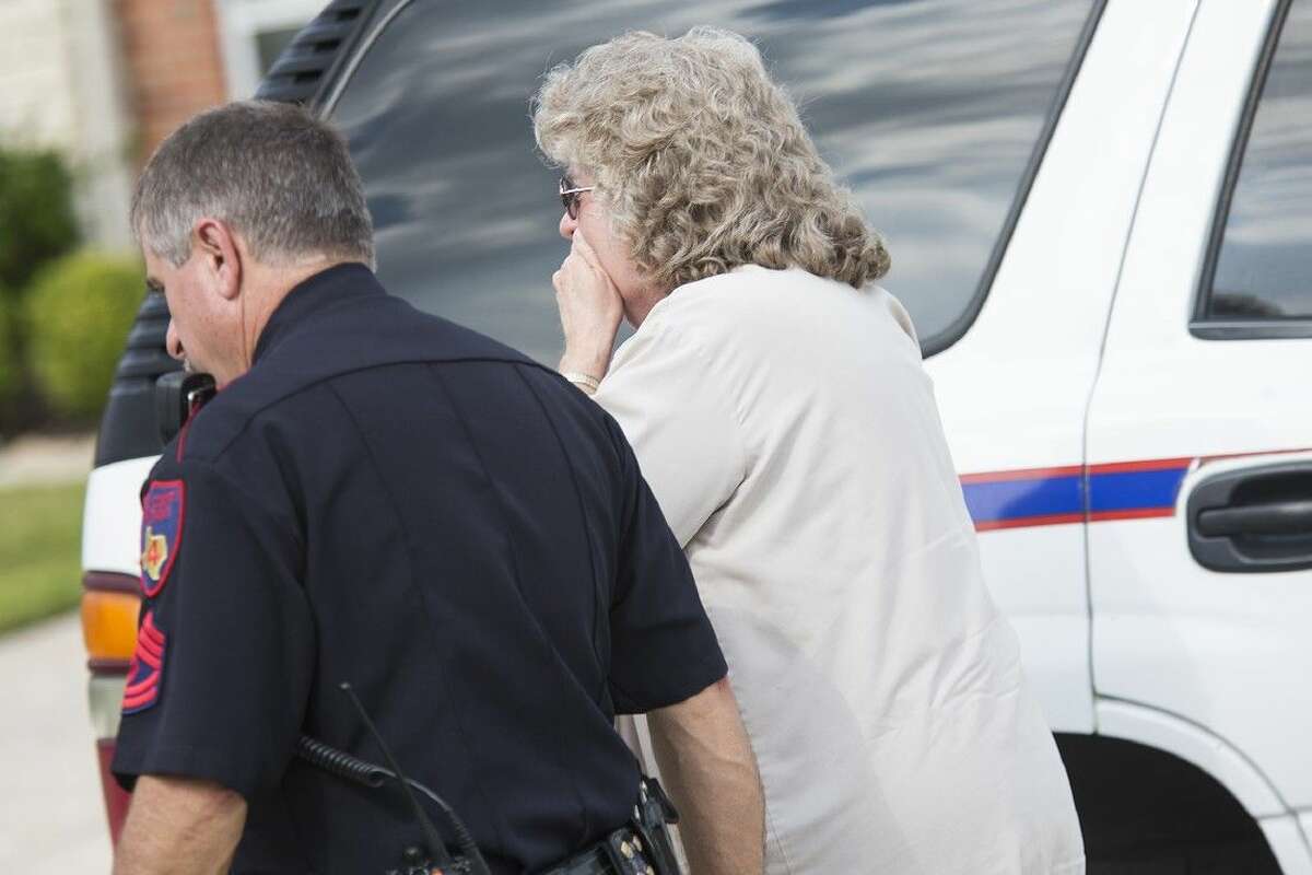A family member reacts to the scene of an attempted burglary on the 8700 block of Rolling Rapids Road in Atascocita.