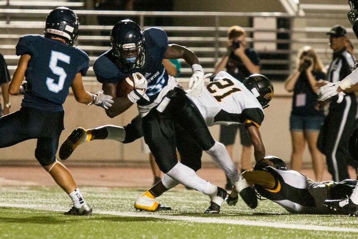 Kingwood's Sewo Olonilua (33) breaks through the defense and dives into the endzone for a touchdown during Kingwood's 20-12 victory over Aldine Eisenhower on Sep. 17, 2015, at Turner Stadium.